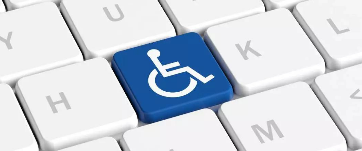 Keyboard with one key replaced with wheelchair accessible symbol.